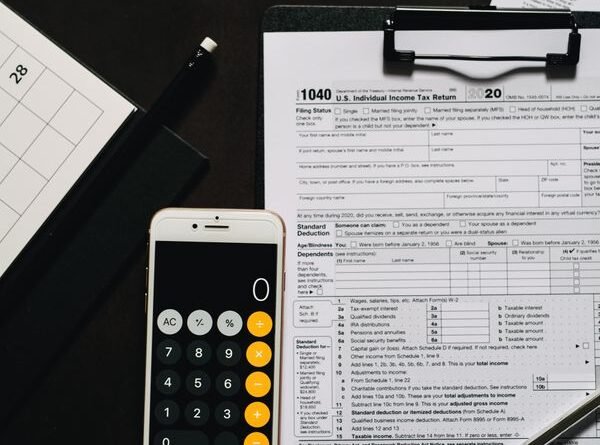 Overhead view of tax forms and calculator for IRS tax preparation
