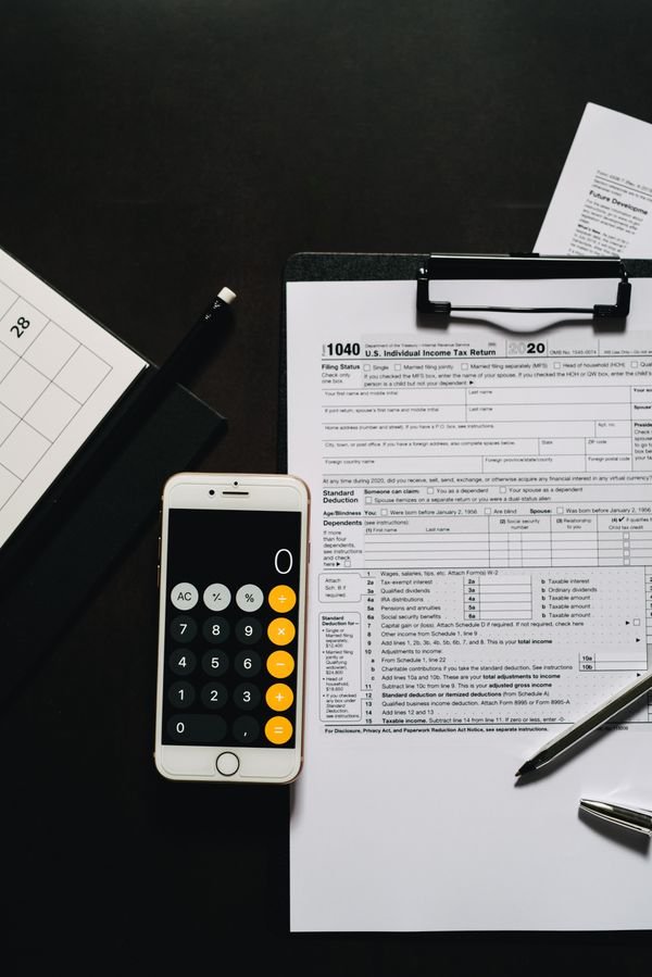 Overhead view of tax forms and calculator for IRS tax preparation