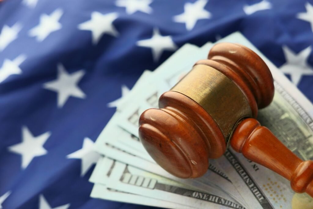 Close-up of a judge's gavel resting on US dollar bills