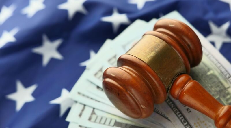 Close-up of a judge's gavel resting on US dollar bills