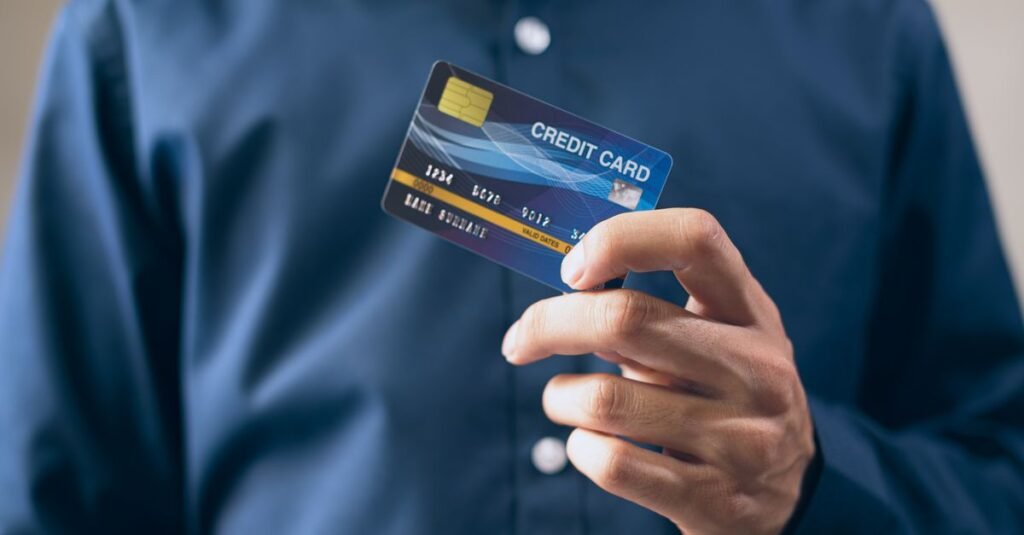 Close-up of a hand holding a credit card, a fresh start for rebuilding credit after debt settlement