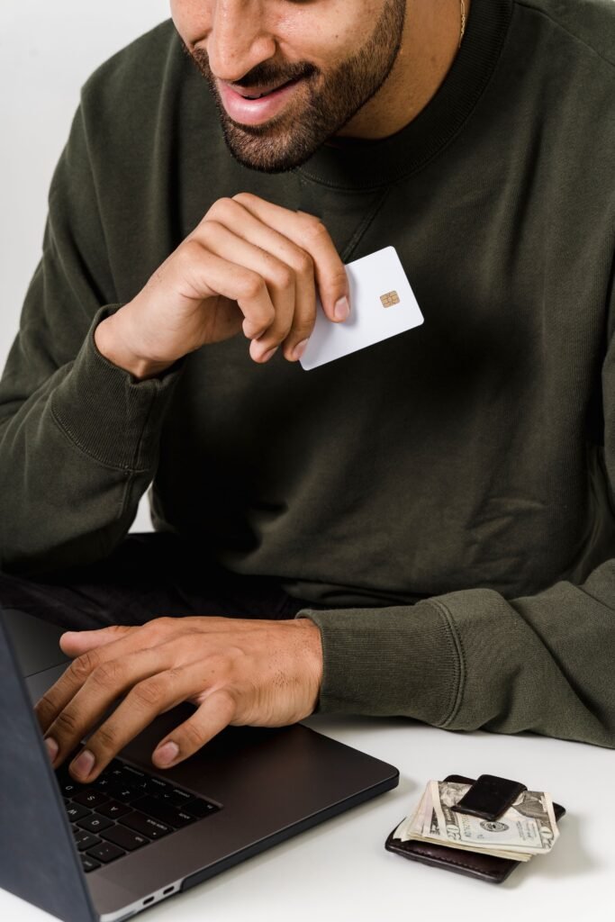 Man holding a credit card while deciding whether to close the account