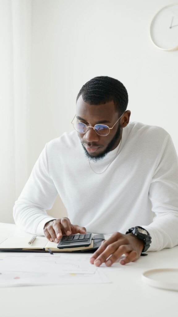 Person planning a debt payoff with a calculator and notebook