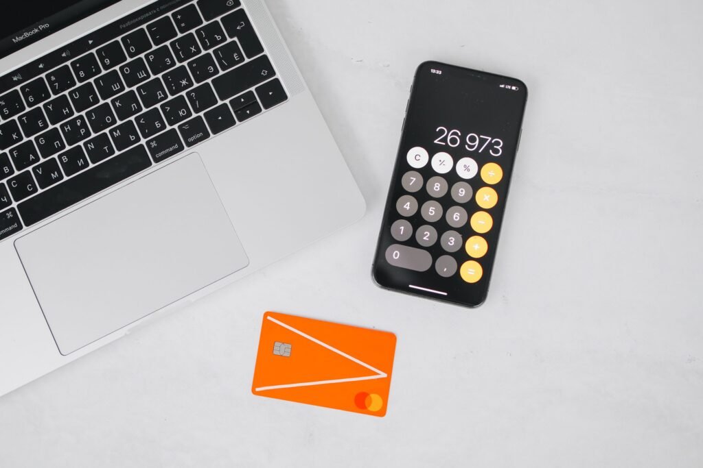 Smartphone calculator next to a credit card on a table