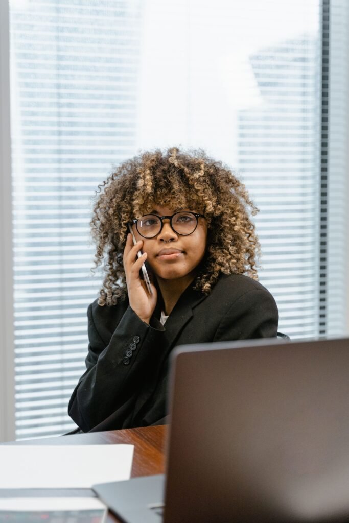 Woman calling her credit card company from a home office to ask for a lower APR