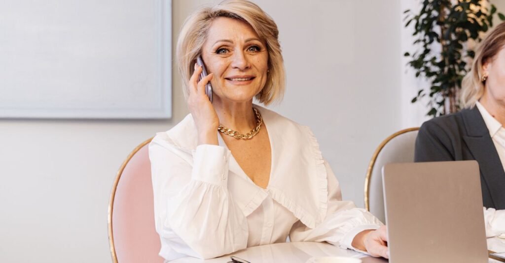 Smiling woman talking on the phone, ready to call her credit card issuer about a hardship program