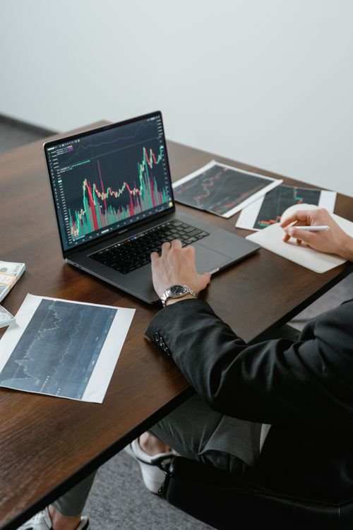 A business analyst reviewing charts on a laptop, representing research into consumer complaint data